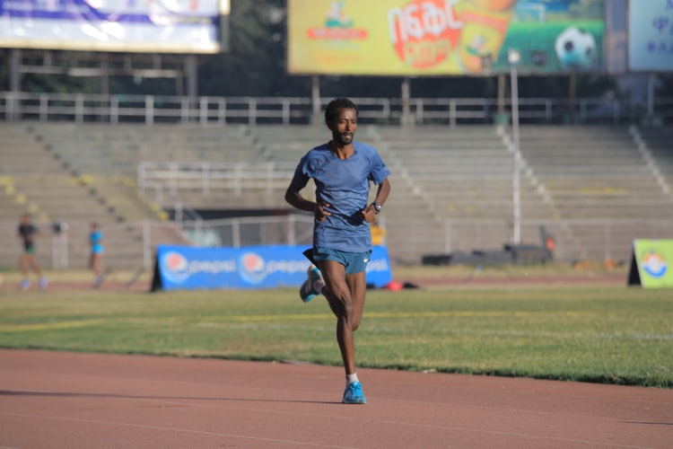 An Ethiopian running in stadium/meskel square